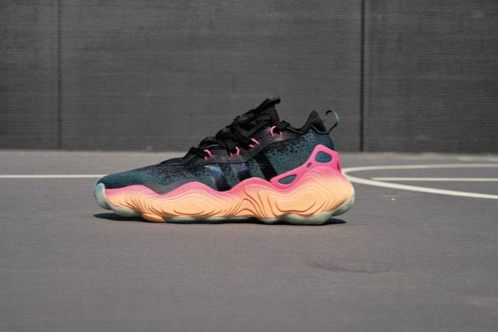 Side view of Trae Young's black and orange adidas sneaker.